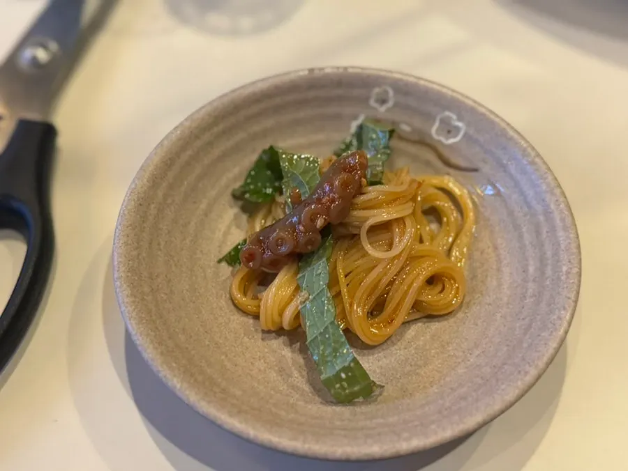 Fermented octopus placed on top of capellini noodles