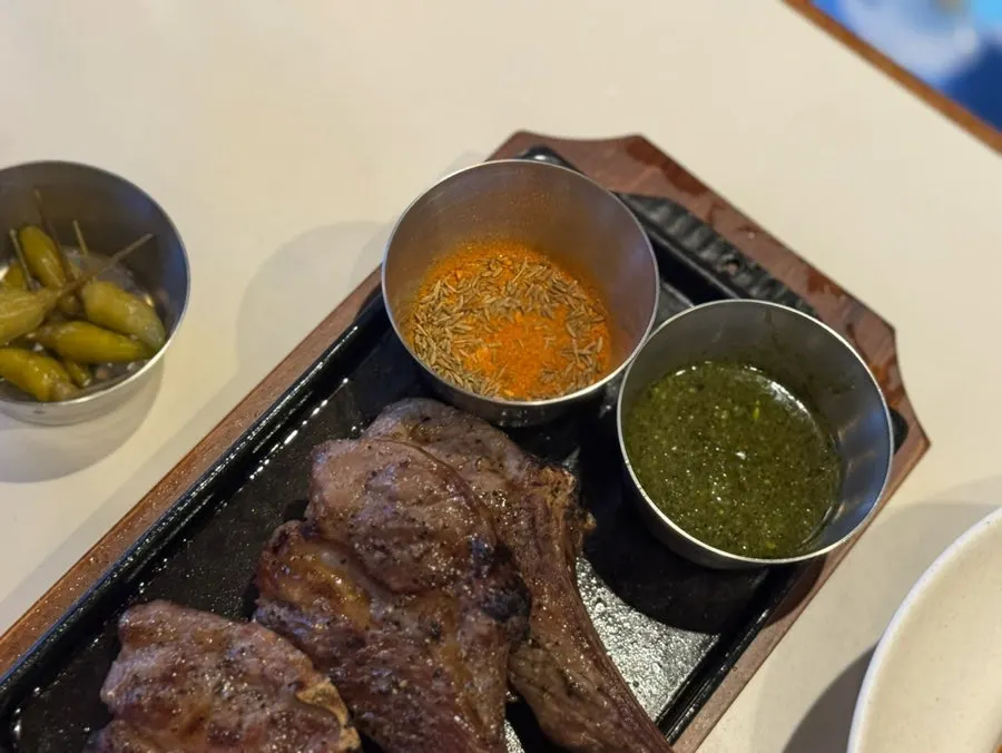 3-piece lamb shoulder rack served on a hot plate