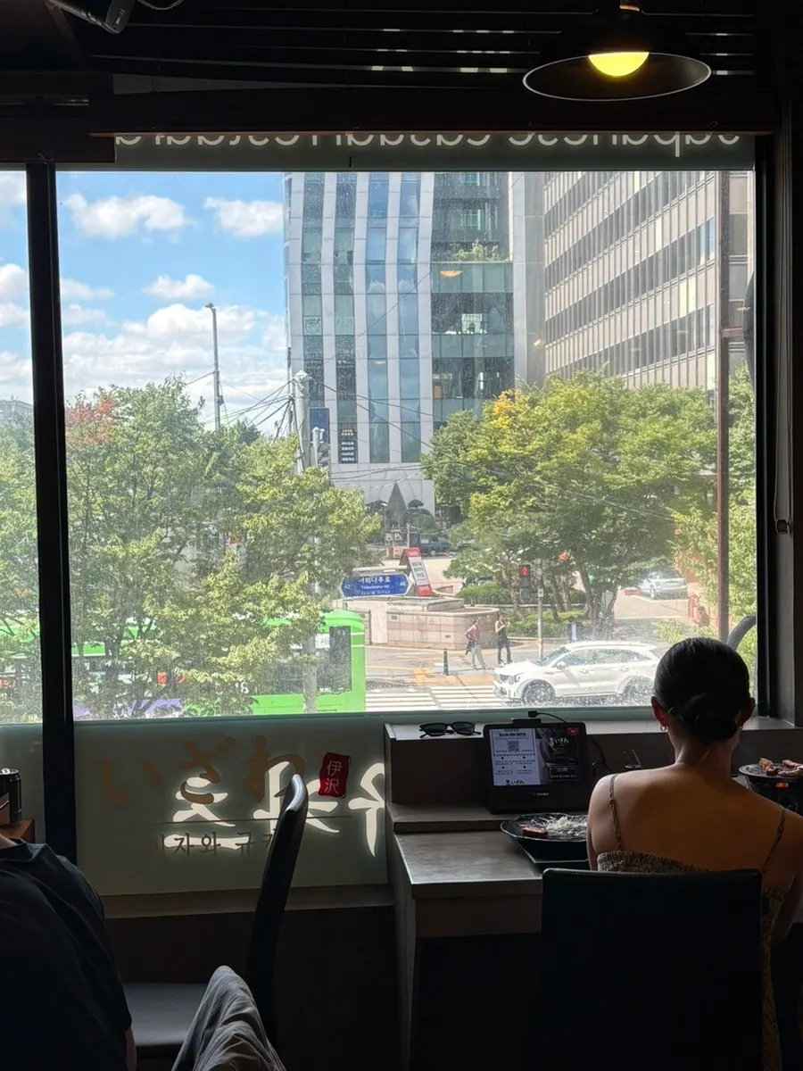Restaurant interior with green scenery visible through the window