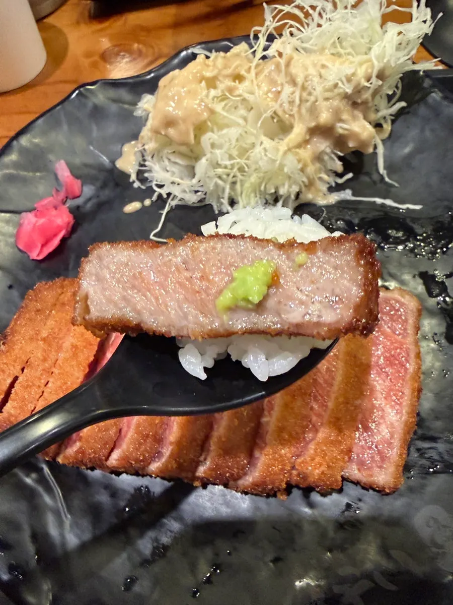 A piece of gyukatsu topped with wasabi