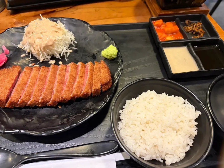 Staff member relighting the tabletop grill