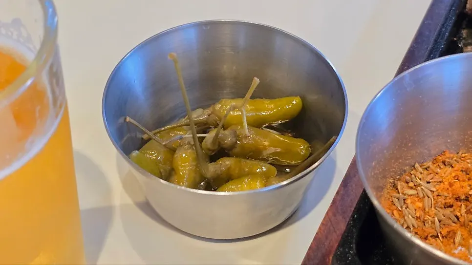 Pickled chili peppers served alongside the lamb