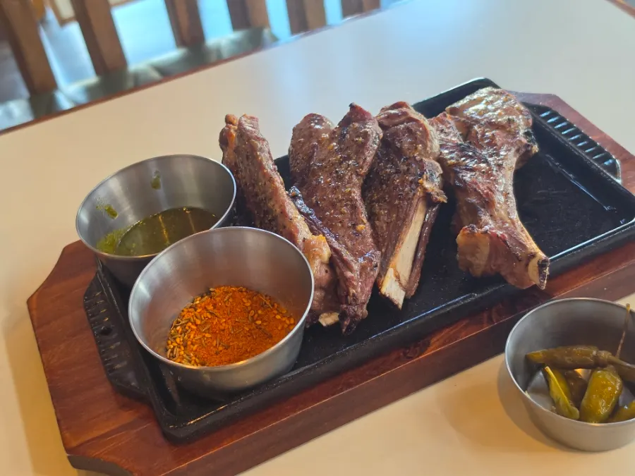 Grilled lamb shoulder rack served with two dipping sauces