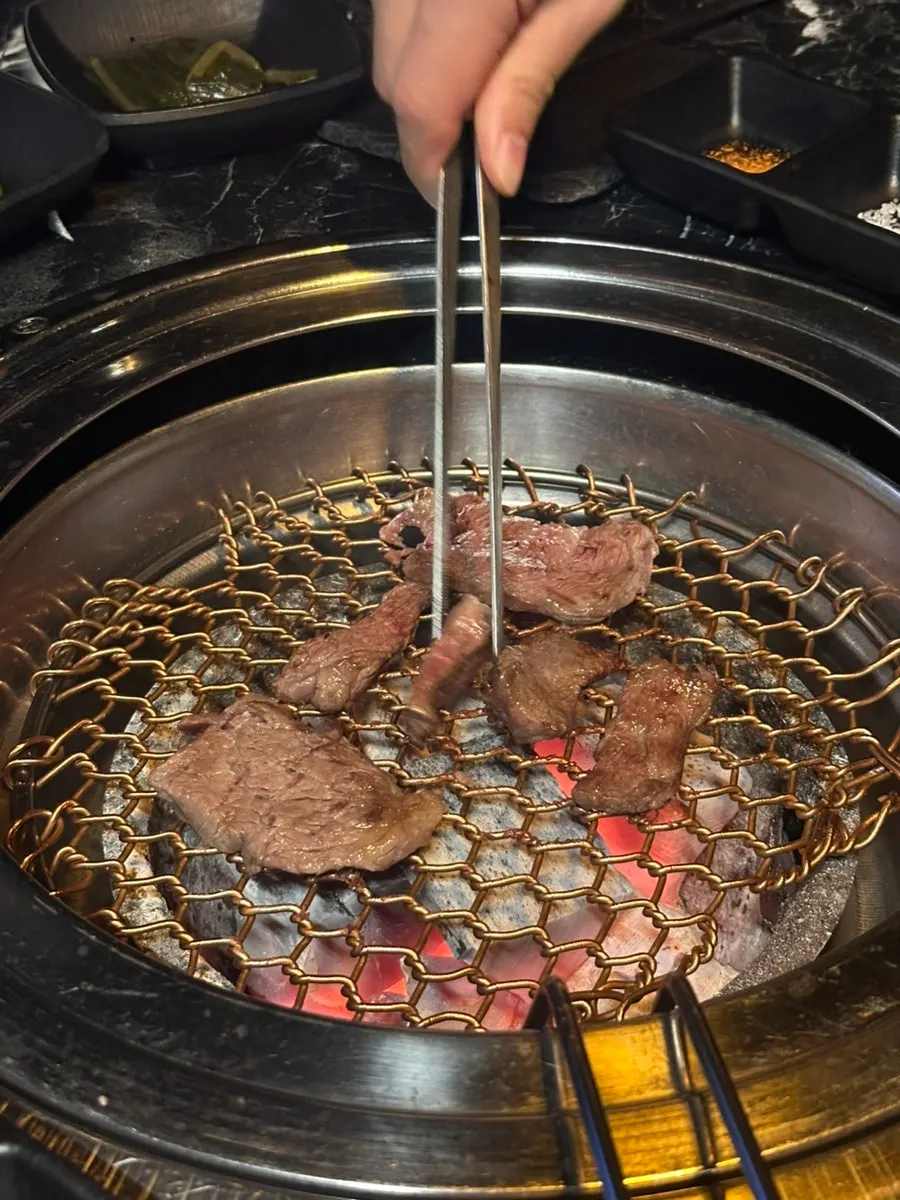 Meat sizzling on a charcoal grill