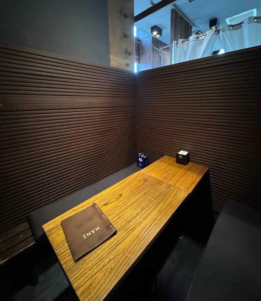 Private seating divided by half-walls and curtains