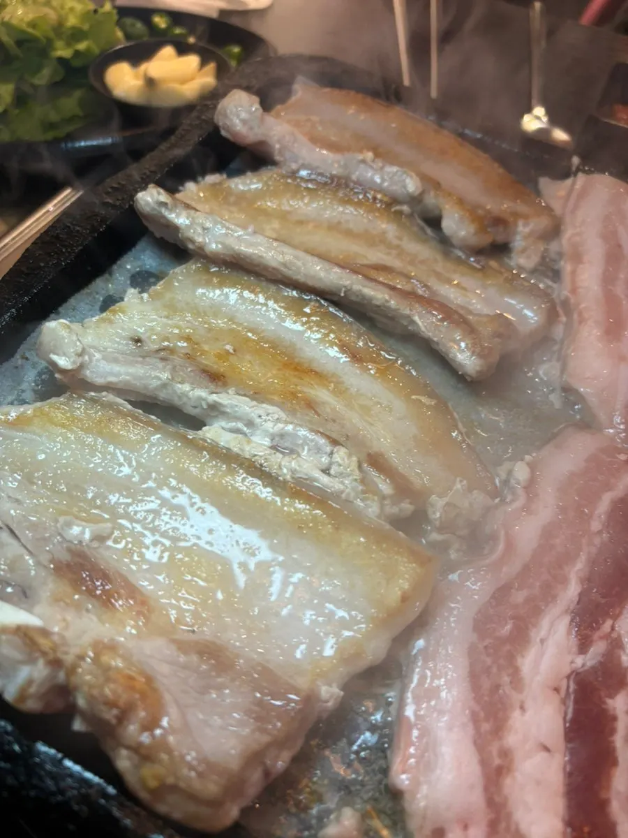 Kimchi and minari sautéing in the meat drippings