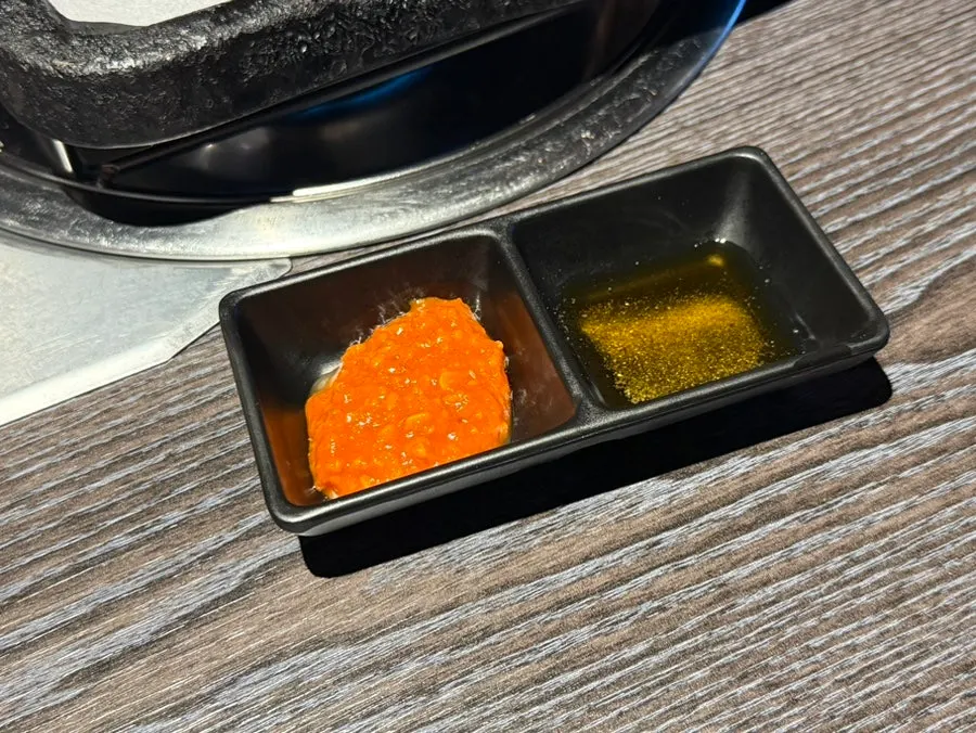 Complimentary kimchi jjigae served with side dishes