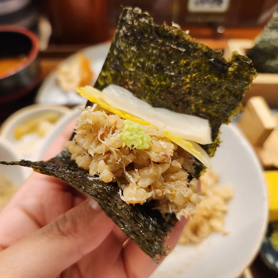 A wrap of seafood and rice in seaweed