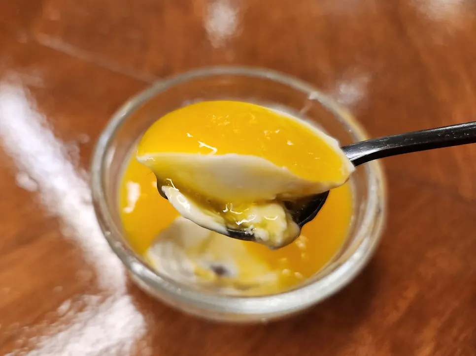 Smooth panna cotta topped with mango purée