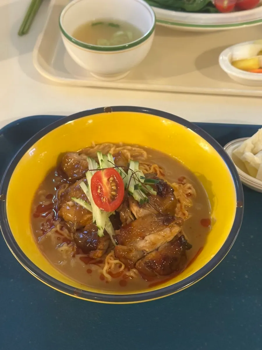 A bowl of sesame chicken noodles at Jeongyun Kitchen