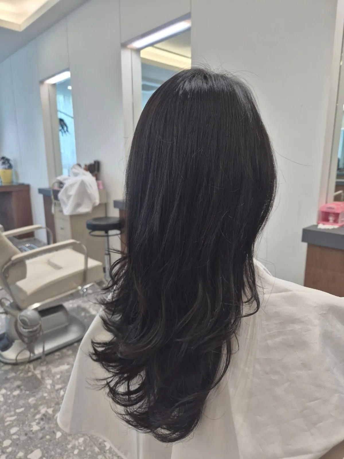 Dark brown dyed hair waiting for blow-dry after shampoo
