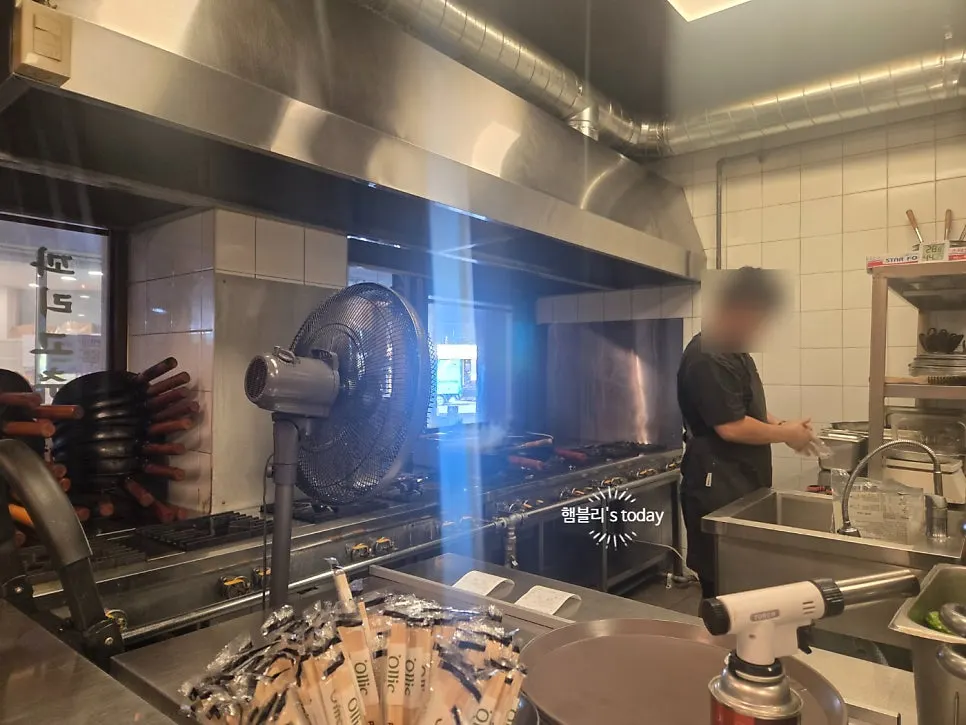 Owner cooking in the open kitchen near the entrance