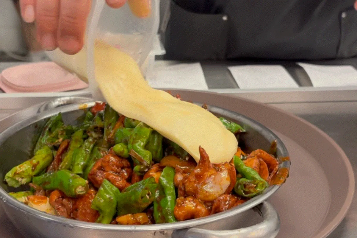 Boneless shishito pepper dakbokkeum topped with cheese