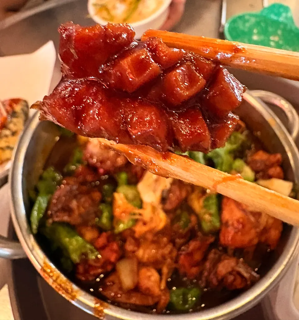 Chopsticks picking up a shishito pepper