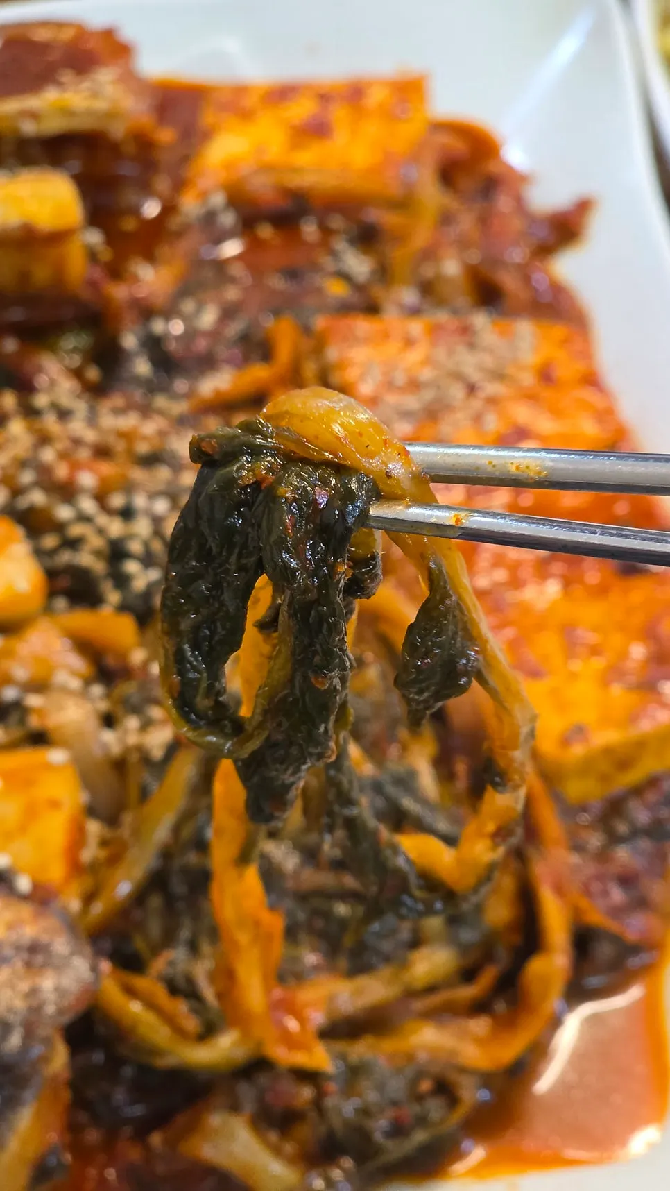 Close-up of radish greens braised in seasoning