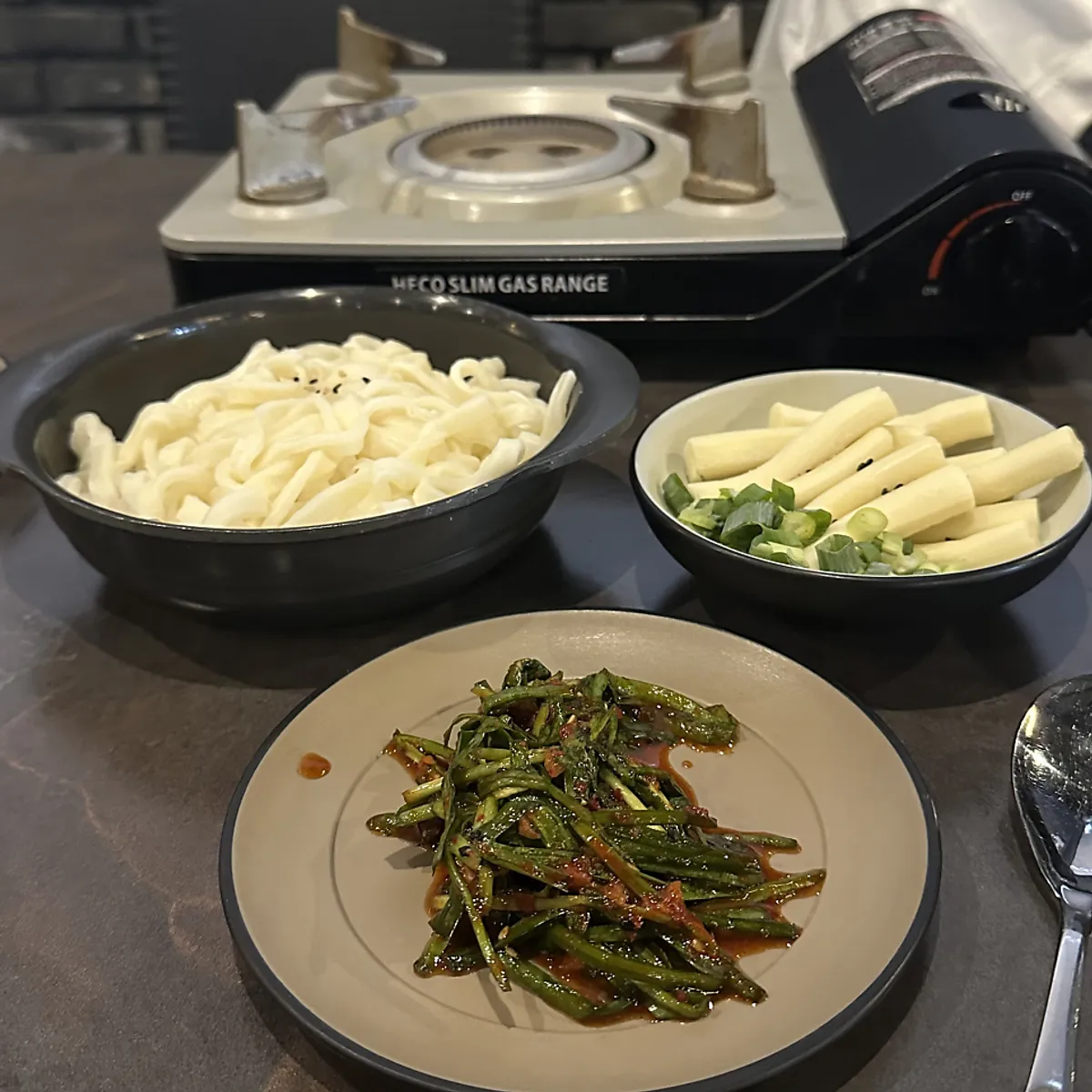 Herbal dak han mari starting to simmer at the table