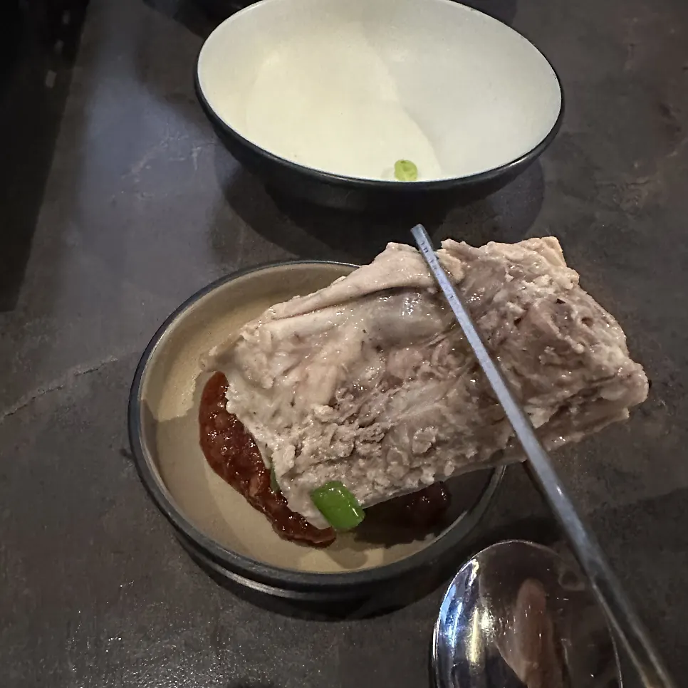 Close-up of dak han mari broth with chives and enoki mushrooms