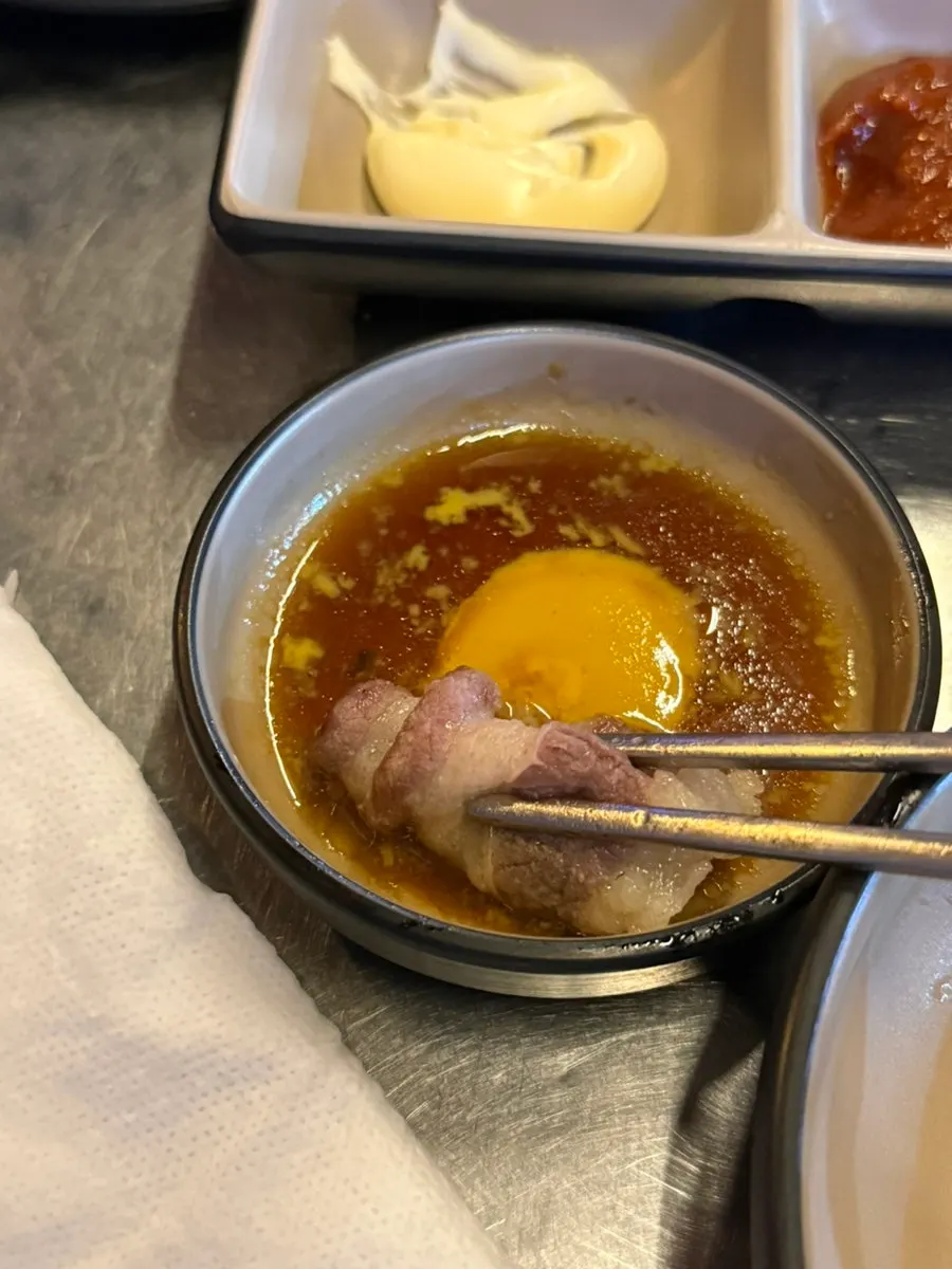A bowl of hot pot with tendon scooped up