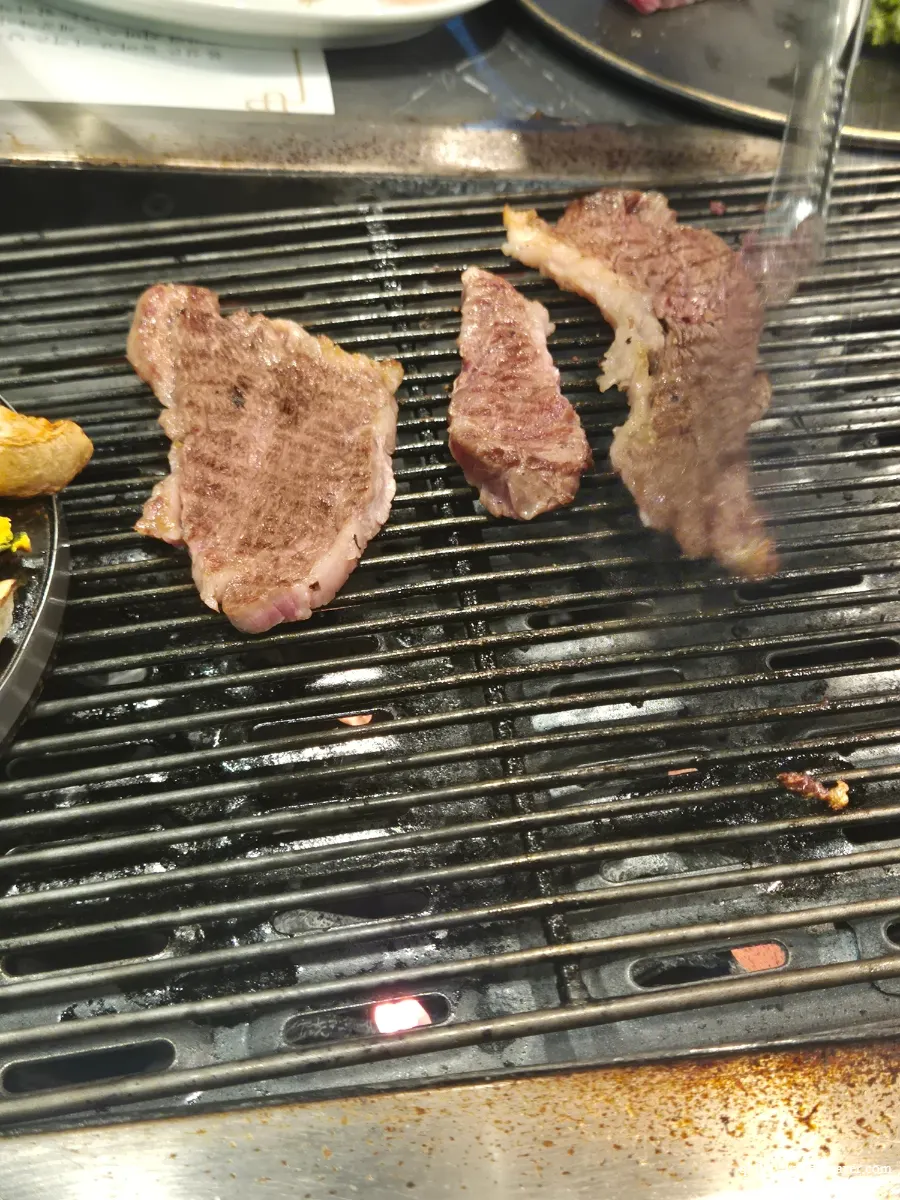 Hanwoo sirloin cooking on the grill