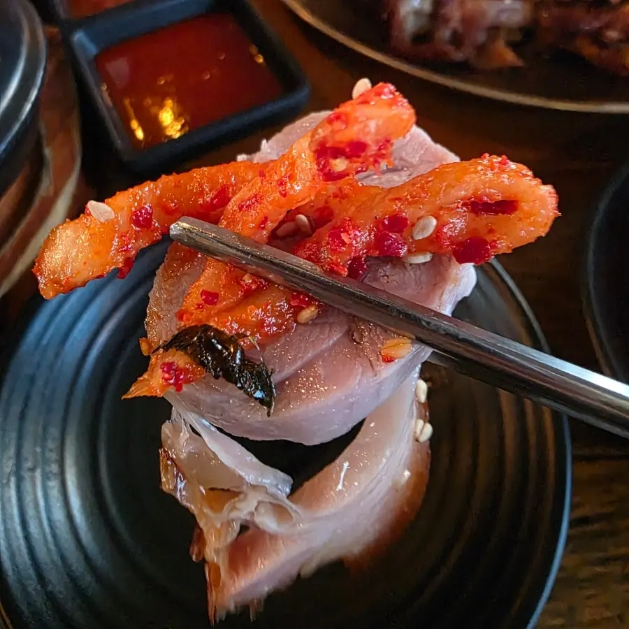 A perilla leaf wrap with jokbal and radish