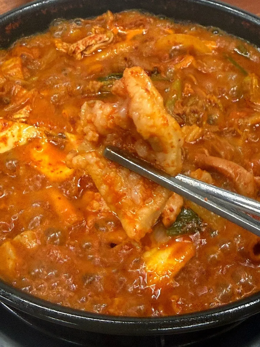 Gopchang hot pot meal with side dishes