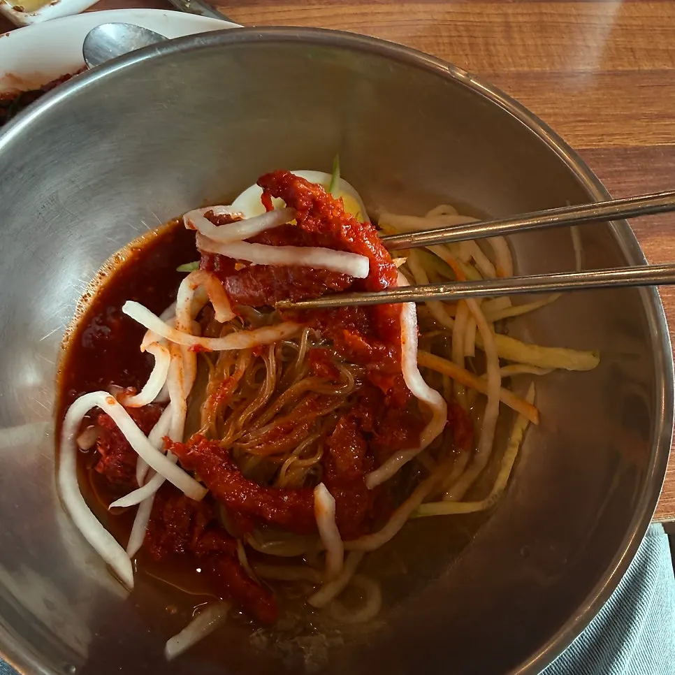 Pollock hoe naengmyeon topped with seasoned pollock in icy broth