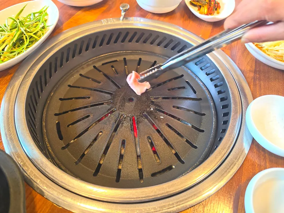 Wiping down the grill plate with pork fat