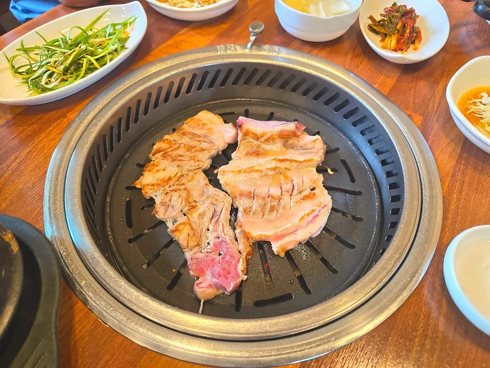 Fresh pork galbi cooking on the charcoal grill