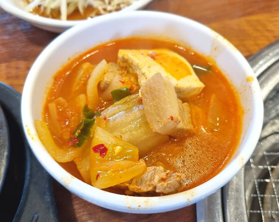 Kimchi jjigae ladled into an individual bowl