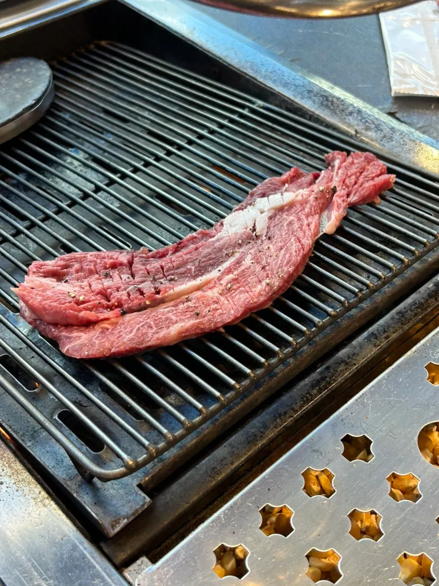Sirloin placed on the corn-fired grill