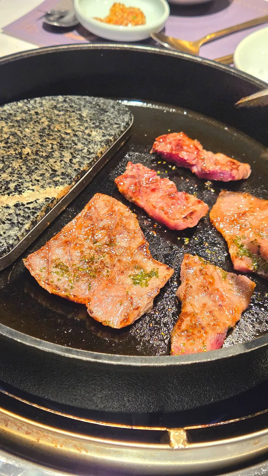 Staff grilling the seasoned galbi golden brown on both sides