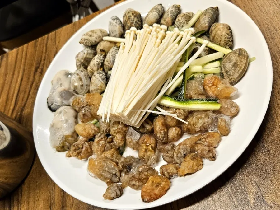 Pufferfish seafood kalguksu on a burner