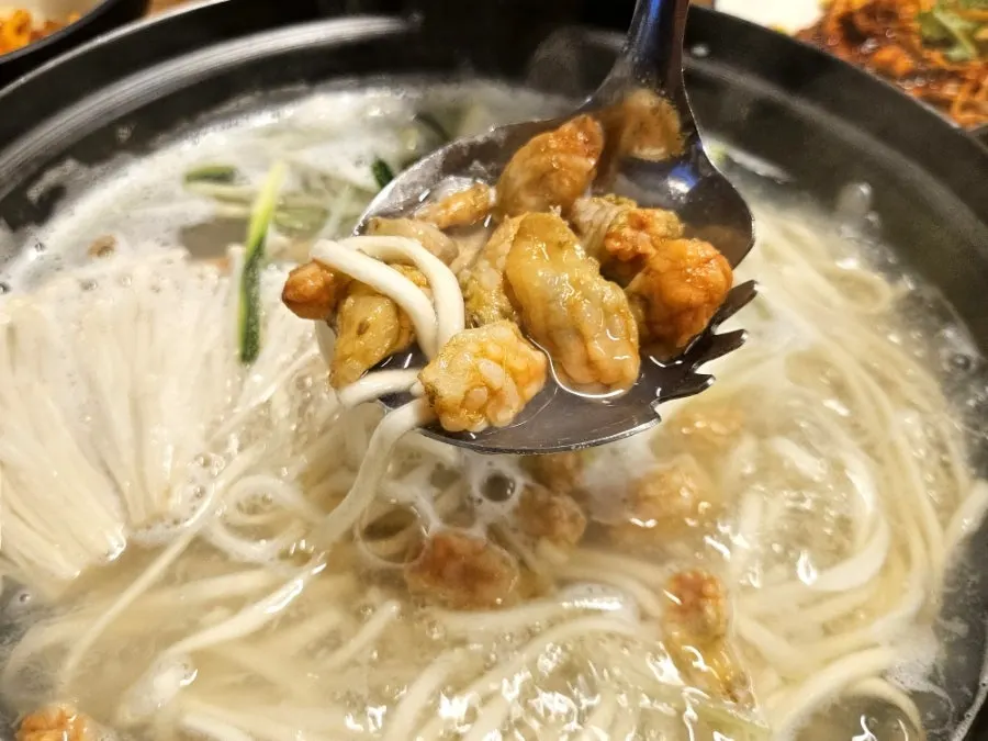 Simmering pufferfish seafood kalguksu broth