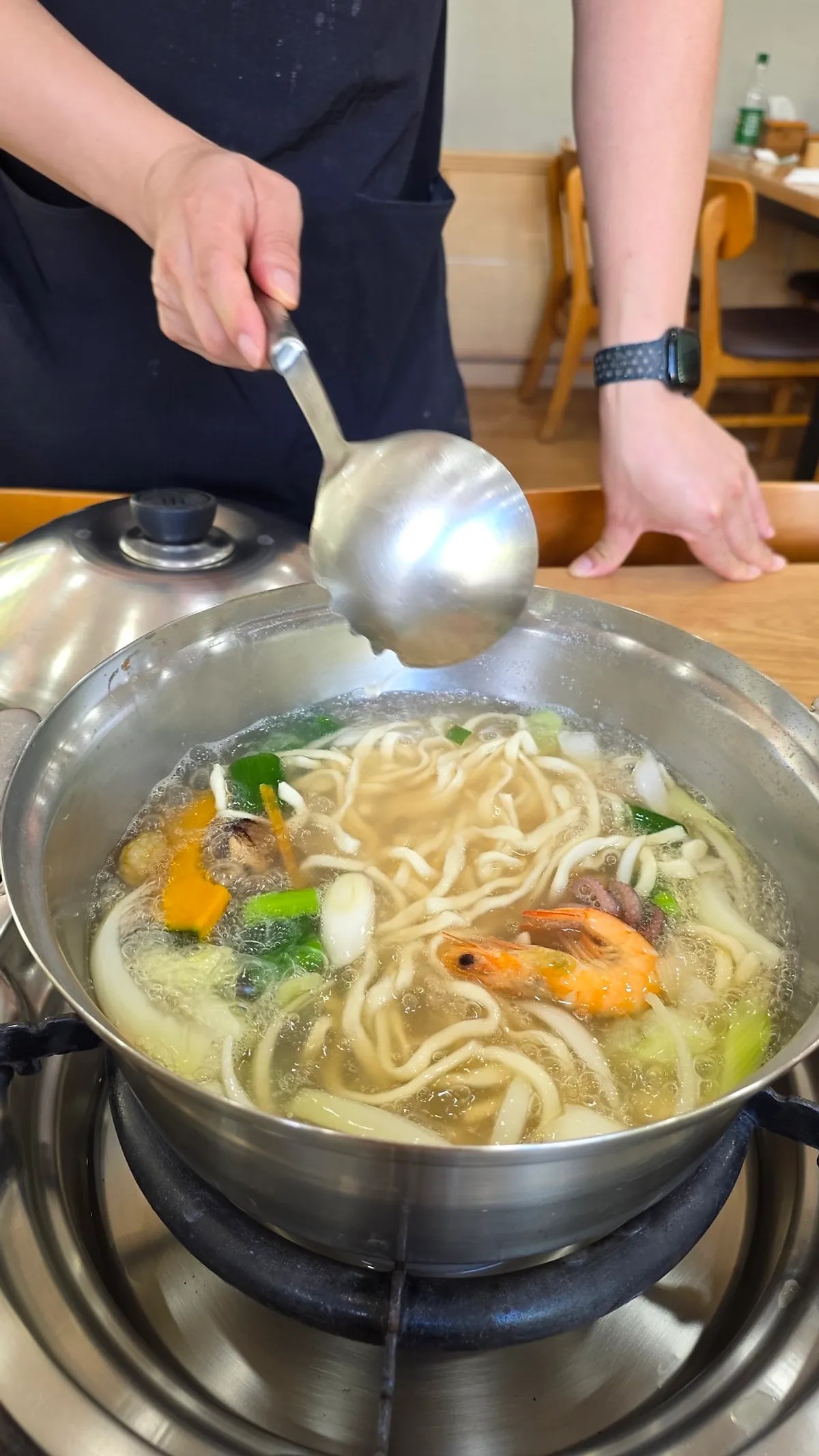 A meal of seafood kalguksu and dumplings