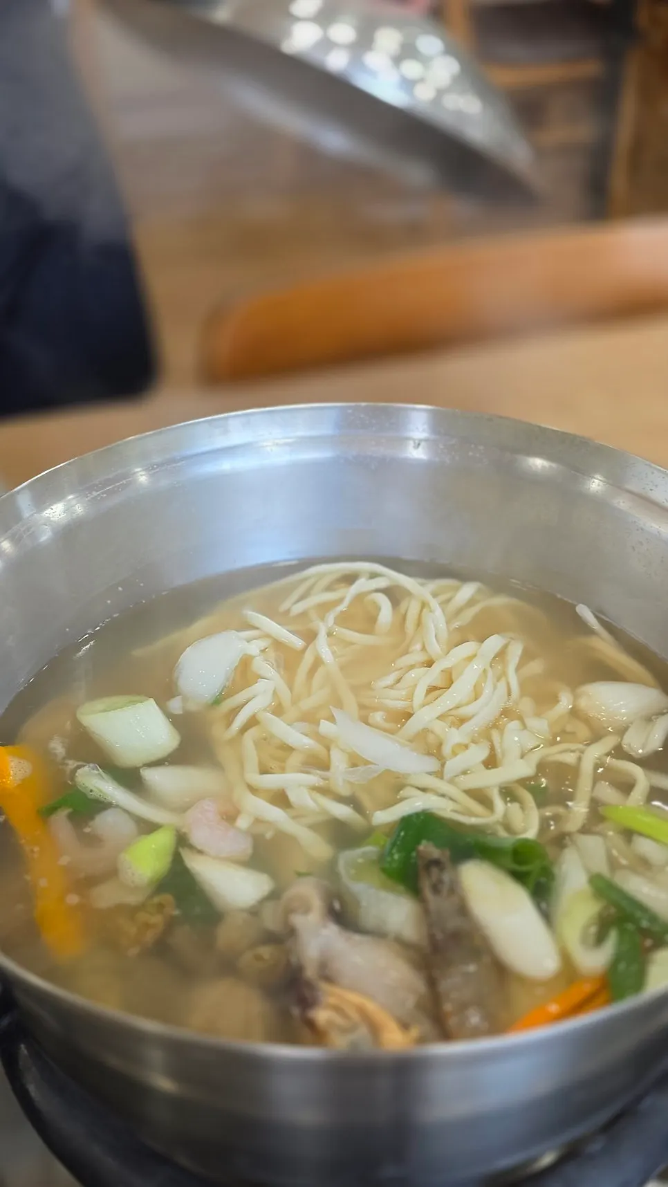 Seafood kalguksu eaten with kimchi
