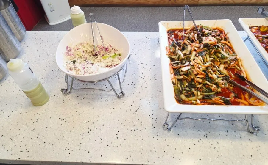Buffet station with assorted Korean side dishes