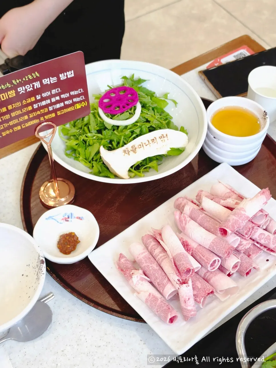 Table set for four with spicy chadol minari wrap shabu kalguksu