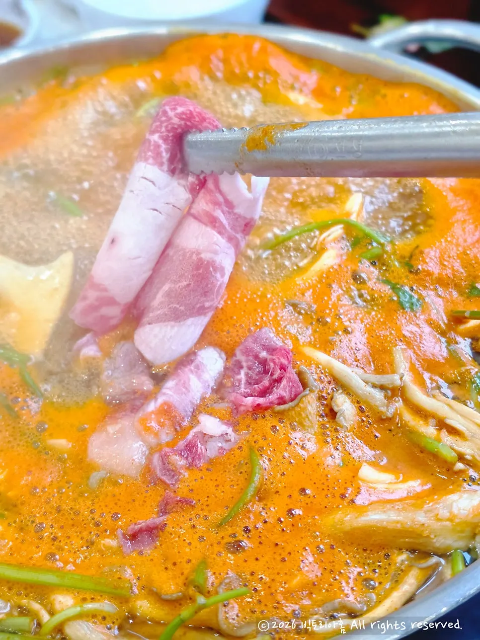 Beef brisket being cooked in the spicy broth for the chami-ssam wrap