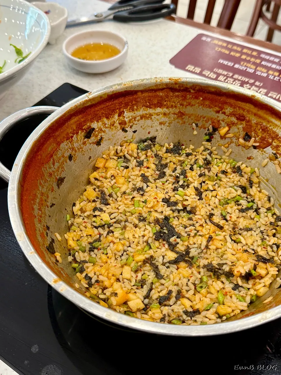 A spoonful of fried rice lifted from the pan