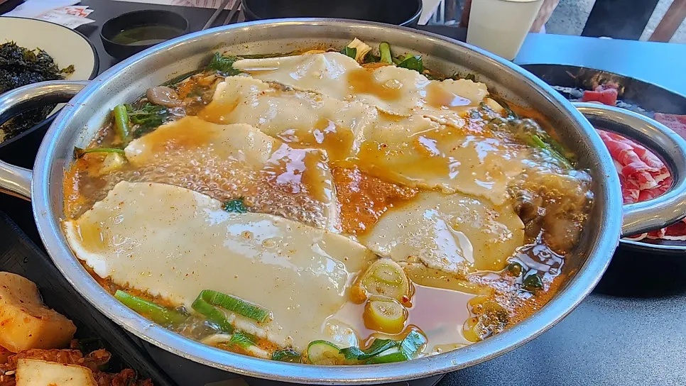 Vegetables and beef cooking in the boiling broth