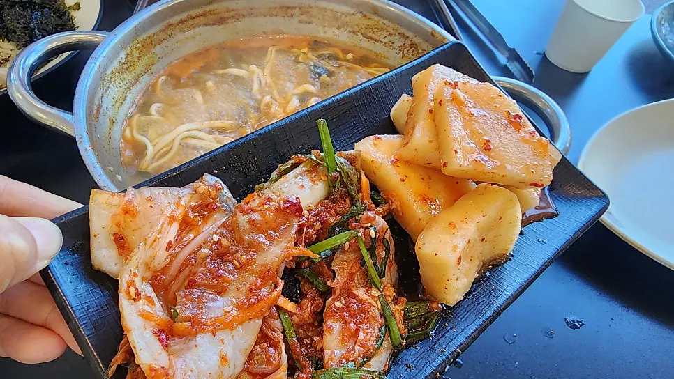Mushrooms and minari added to the shabu broth