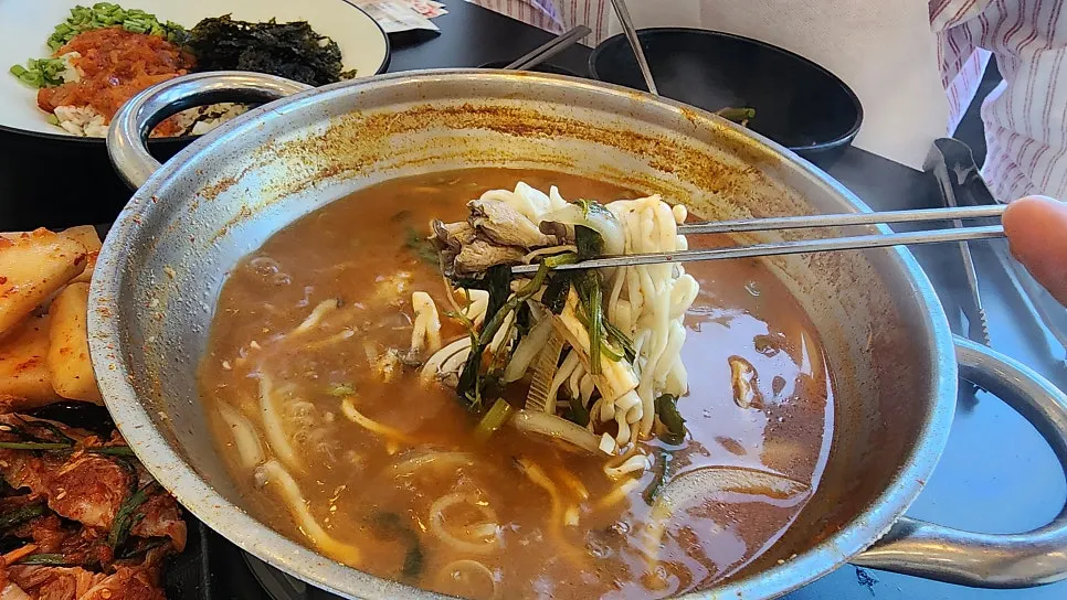 Self-made kalguksu noodles added to the broth