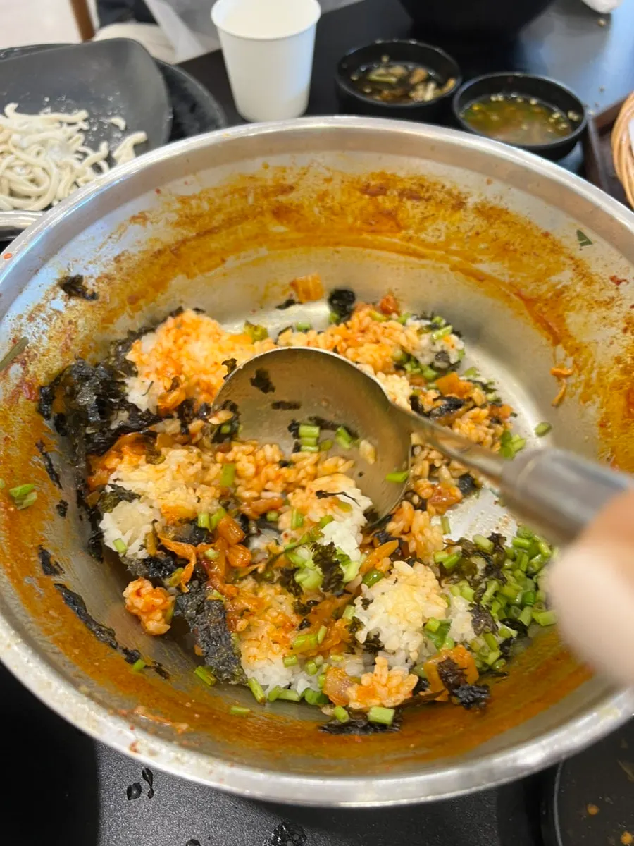 Fried rice being stir-fried to finish the meal