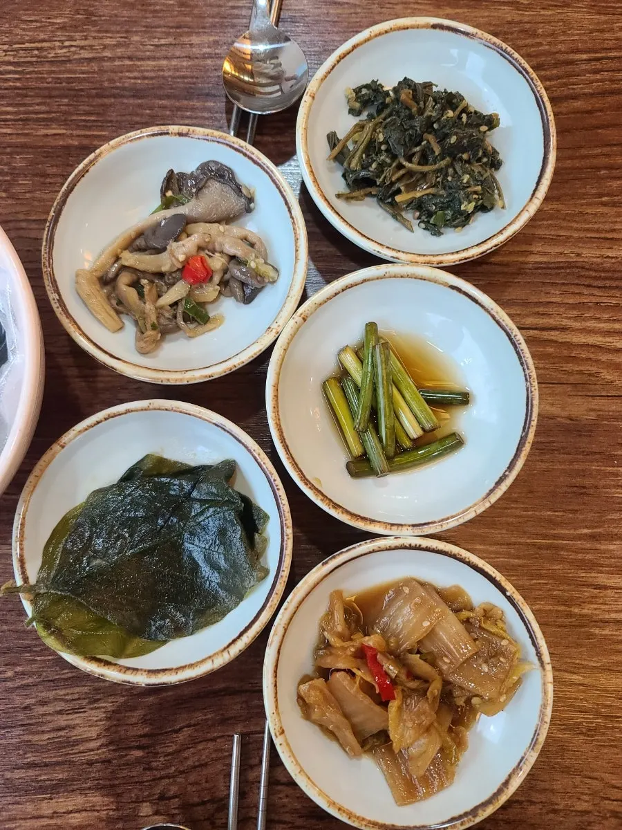 Side dishes being set out on the table