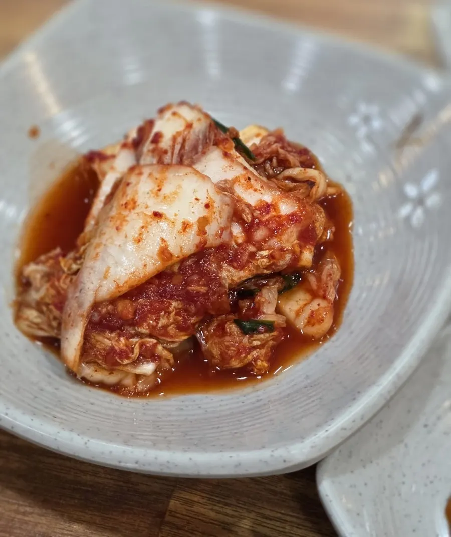 Napa cabbage kimchi side dish described as sticking to your palate