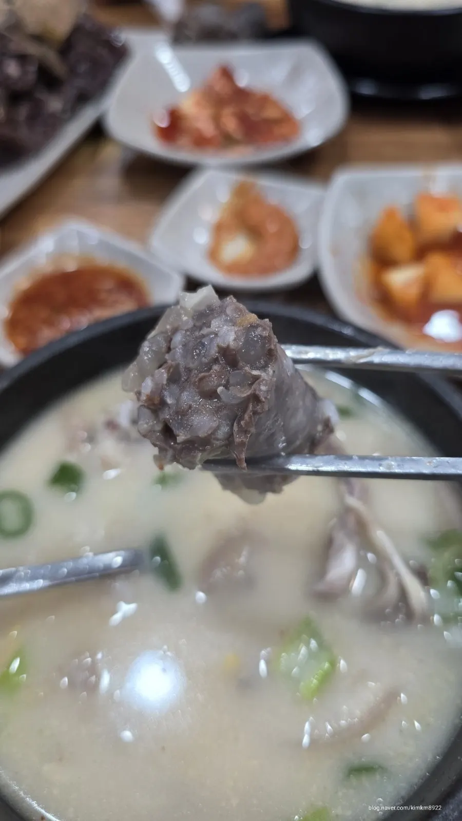 A spoonful of rice mixed with meat and kimchi from the sundaeguk