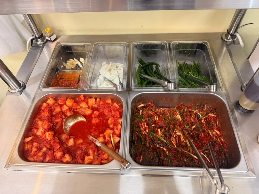 Kimchi and basic side dishes taken from the self-serve bar