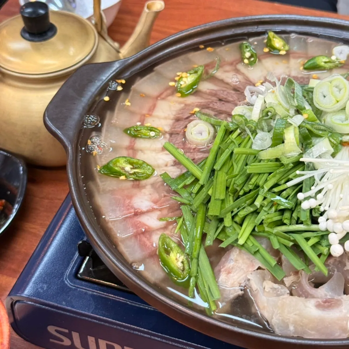 Single portion of sosuyuk jeongol packed with meat and ingredients