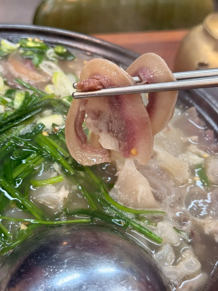 A piece of boiled pork dipped in chili soy sauce
