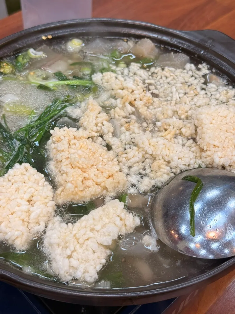 A spoonful of boiled pork hot pot with broth